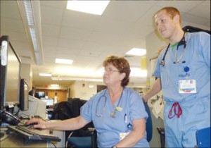 At the Whidden Hospital, a flu-like sickness known as ‘ILI’ has wreaked havoc on local residents – increasing ER volumes at the hospital by 40 or 50 percent. Here, Jackie MacKay, RN, (a Revere resident) discusses symptoms of a patient on Monday with Gabe Tash, PAC.