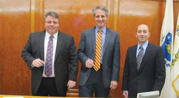 Revere Mayor Daniel Rizzo (left) , Mohegan Sun Chief Operating Officer Mitchell Etess (center), and Revere City Solicitor Paul Capizzi are pictured at Revere City Hall Monday where a host com¬munity agreement for a $1 billion resort casino at Suffolk Downs was signed that would guaran¬tee Revere between $25 million and $30 million in annual revenue, with the potential of that to gro beyond $40 million a year.