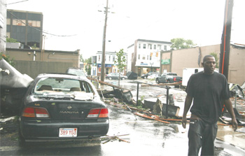 Victor Villena is shown here moments after the tornado passed through Park Avenue. He was in the black car to the left when the tornado struck. Large pieces of Peter Woo’s roof smashed onto his car as he sat inside. “I’m still shaking; it was terrifying,” he said.